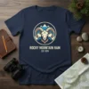 Rocky Mountain Ram Est. 1978 t-shirt featuring a circular graphic with a ram's head and mountains, navy blue shirt
