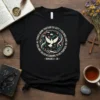 Black t-shirt with circular design featuring a dove, crown, and text "ALL THINGS WORK TOGETHER FOR GOOD TO THOSE WHO