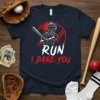 Baseball catcher ready to swing with "RUN I DARE YOU" text on a navy t-shirt