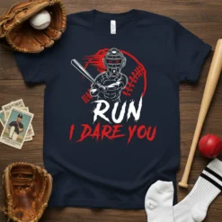 Baseball catcher ready to swing with "RUN I DARE YOU" text on a navy t-shirt