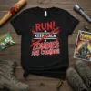 Black t-shirt with "RUN KEEP CALM ZOMBIES ARE COMING!!" text in red and white, designed for zombie apocalypse fans