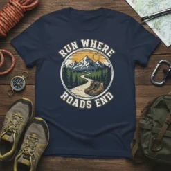 Run Where Roads End hiking t-shirt featuring a mountain landscape, pine trees, and hiking boots