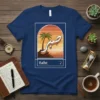Sabr. Arabic calligraphy t-shirt featuring a sunset beach scene with a palm tree and the word Sabr