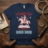 Saddle Up with a GOOD BOOK t-shirt design featuring a cowgirl riding a horse on an open book, red and