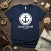 Sailor's Anchor Est. 1873 graphic tee with a white anchor inside a rope circle on a navy blue t-shirt