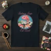 Salmon Says Eat Sushi text design with a cute salmon fish and assorted sushi pieces on a navy t-shirt