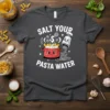 Salt Your Pasta Water t-shirt featuring a cute pot of pasta and a smiling salt shaker pouring salt into water
