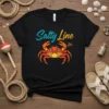 Black t-shirt with "Salty Line" text and a colorful geometric crab design, perfect for beach lovers