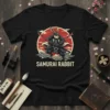 Samurai Rabbit T-Shirt featuring a rabbit warrior in armor holding katanas against a red sun and clouds