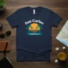 San Carlos Venezuela text with tropical sunset and palm trees graphic on a navy t-shirt
