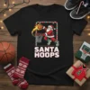 Santa Hoops Christmas T-Shirt design showing Santa Claus dunking a basketball, with festive border