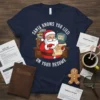 Navy t-shirt with Santa at a desk, holding a scroll, that says SANTA KNOWS YOU LIED ON YOUR RESUME
