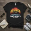 Black t-shirt with vintage Santa Monica Pier California sunset graphic and palm trees