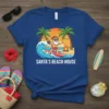 Santa's Beach House t-shirt design with Santa surfing a wave, palm trees, and beach scene