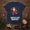 Santa Claus wearing a kilt and playing bagpipes with "Santa's Got Bagpipes" text on a navy blue t-shirt