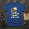 Save Water Drink Whiskey quote on a blue t-shirt with a graphic of a whiskey glass and shield