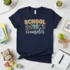 SCHOOL COUNSELOR text with colorful graphics including a rainbow, tree, and peace sign on a navy t-shirt