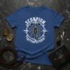 Scorpion Tattoo Studio text with a scorpion graphic on a blue t-shirt, designed for tattoo artists