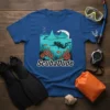 ScubaDude t-shirt design featuring a diver, manta ray, coral, and fish in an underwater scene