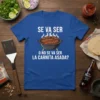 T-shirt with white text "Se Va Ser O No Se Va Ser La Carnita Asada?" above a cartoon grill with