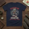 Graphic t-shirt design featuring a muscular raccoon character on books, with text "SEASON 60 EPISODE ONE SIXTY & STILL FER