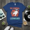 Sei Einmal Leiwand German quote t-shirt with a white cat wearing sunglasses sitting in an armchair with books