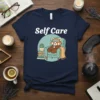 Self Care t-shirt with a red panda relaxing in a chair, text "Self Care" above