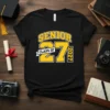 Black t-shirt with bold yellow text "SENIOR CLASS OF 27 2027" for graduation celebration