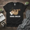 Black t-shirt with "SERIAL CHILLER" text and a cartoon sloth sleeping on a pillow and tree branch