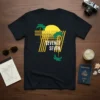 Black t-shirt with "SEVENTY SEVEN" text, palm trees, and a yellow sun in a retro 70s graphic style