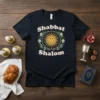 Shabbat Shalom T-Shirt with a smiling sun graphic surrounded by floral wreath