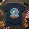 Shark Attack Pizza t-shirt design featuring a shark surfing a pizza slice on a wave