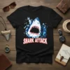 Black t-shirt with a fierce shark jumping out of the water, text reads "Shark Attack"