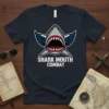 Shark Mouth Combat design on a navy blue t-shirt with a fierce shark head, pilot wings, and combat text