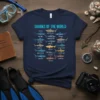 T-shirt displaying "SHARKS OF THE WORLD" title above a grid of various shark illustrations with their names, including Blue Shark