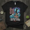 Black t-shirt with bold pink and white text "They Whispered You Can't Withstand The Storm She Whispered Back I Am