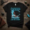 Black t-shirt with blue text "They whispered to her YOU CAN'T WITHSTAND the storm She whispered back I AM THE