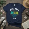 Shell Yeah 2024 t-shirt with three colorful sea turtles swimming in a sunburst graphic