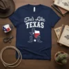 She's Like TEXAS text design with Texas map and cowboy boots graphic on a navy t-shirt