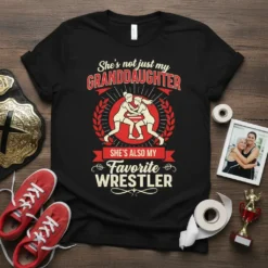 T-shirt with "She's not just my GRANDDAUGHTER SHE'S ALSO MY Favorite WRESTLER" text and graphic of two female wrestlers in