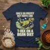T-shirt with text "She's So Pretty But Farts Like T-Rex On A Bean Diet" and a cartoon T-Rex releasing gas