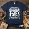 Funny T-Rex dinosaur graphic with text "She's So Pretty But She Farts Like A T-Rex On A Bean Diet!"