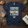 Navy t-shirt with white text: SHHHH & Bring Your Mom A Coffee, featuring a shushing finger icon and a coffee