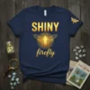 Shiny Firefly t-shirt design with glowing firefly graphic and text, dark navy blue shirt