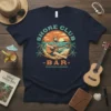 Shore Club Bar Cocktails & Chords t-shirt design featuring a man playing guitar on a beach with palm trees and