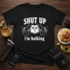 Funny "SHUT UP i'm bulking" t-shirt design with cartoon gorilla lifting weights