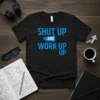 Black t-shirt with blue text reading "SHUT UP AND WORK UP UP", featuring a megaphone graphic