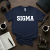 Navy blue t-shirt with white collegiate-style 'SIGMA' text, presented on a wooden surface with coffee and headphones