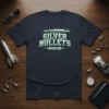 Navy t-shirt with "SILVER BULLETS EST. 2024" text and a stylized bullet graphic in white and green