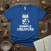 Simple Creature t-shirt with a white geometric owl design and text below, displayed on a royal blue tee